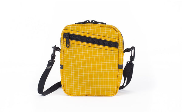 An Everyday Cubelet in Solaris Halcyon (yellow with a white grid) with a front zipper.
